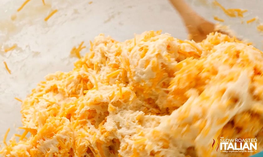 mixing shredded cheddar into red lobster biscuit dough