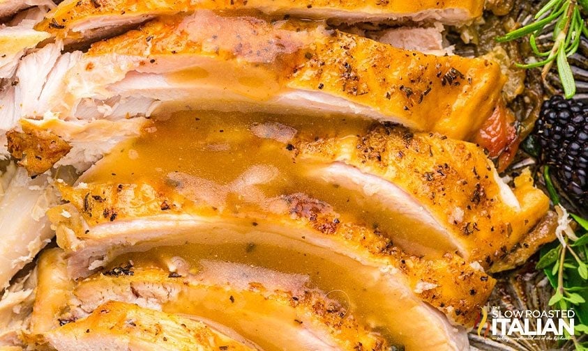 slices of crock pot turkey breast drizzled with gravy