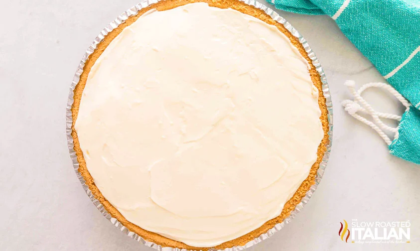 3 ingredient no bake cheesecake filling smoothed into pie crust