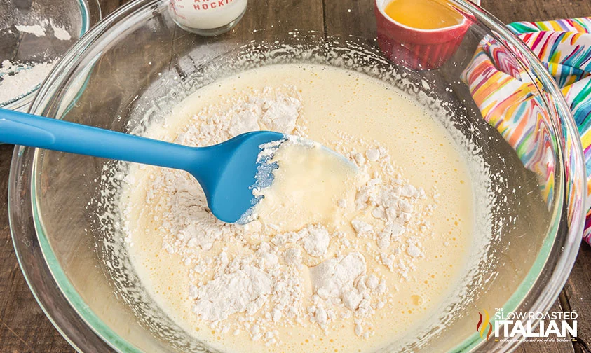 mixing batter for Italian lemon cake with blue spatula
