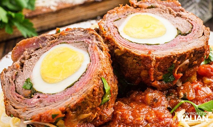 beef stuffed with hard boiled egg, salami, herbs, and cheese sliced open