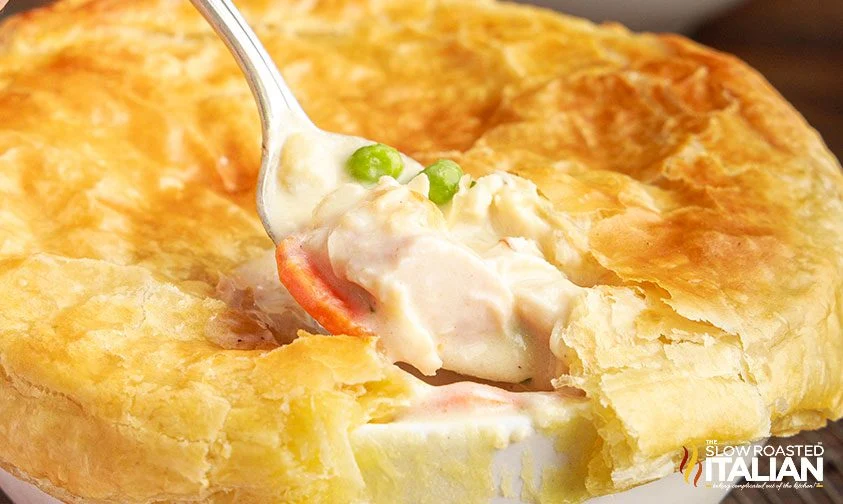 pulling spoonful of filling from homemade chicken pot pie