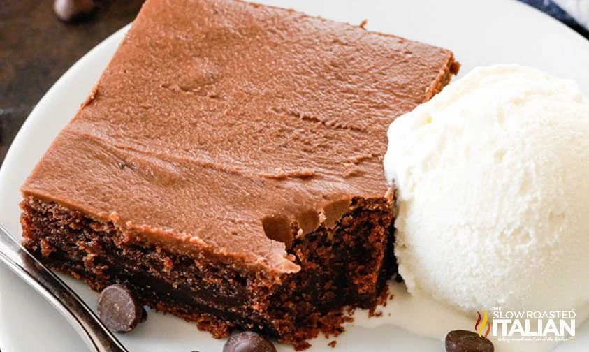 slice of cracker barrel chocolate coke cake on a plate with vanilla ice cream