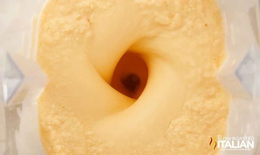 blending orange creamsicle milkshake in blender