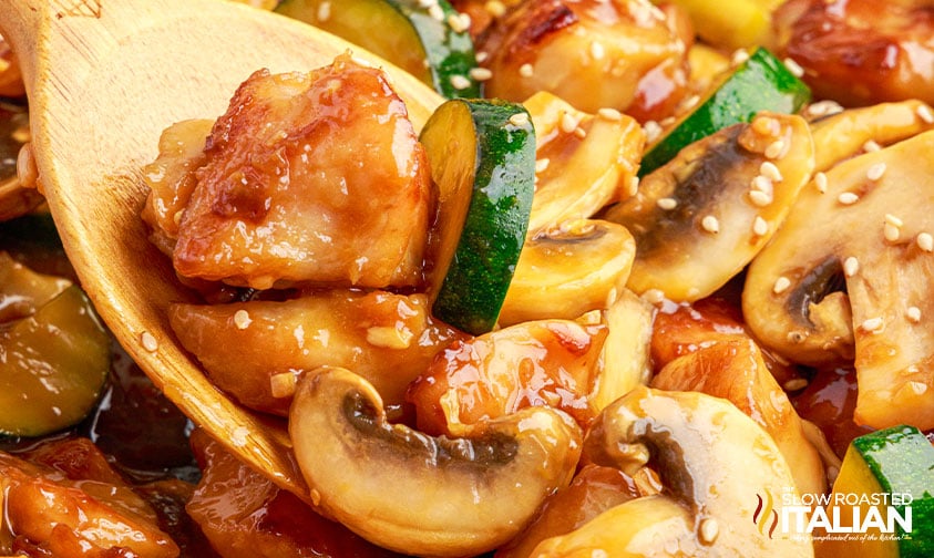 stirring mushroom chicken and zucchini with sauce and sesame seeds