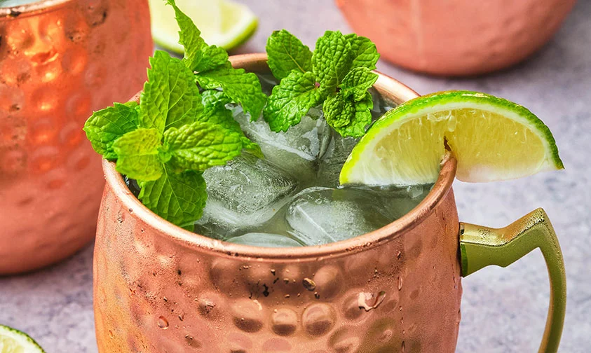 Irish Mule cocktail in copper mug topped with mint sprig and wedge of lime
