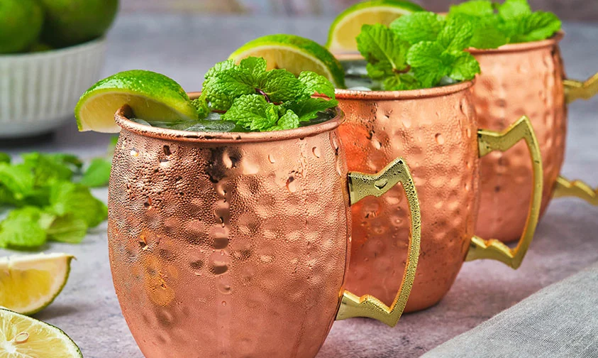 row of Irish Mule drinks topped with lime wedge and fresh mint