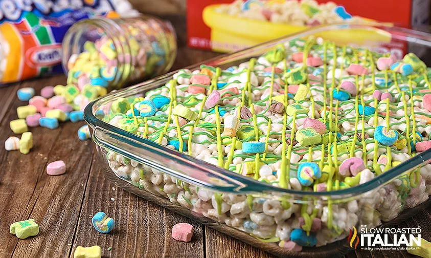 pan of lucky charms marshmallow treats drizzled in green coating chocolate