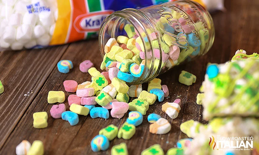 Lucky Charms cereal marshmallows spilling out of a glass jar