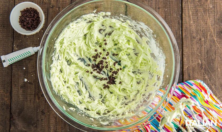green mint frosting with chocolate chips in glass bowl