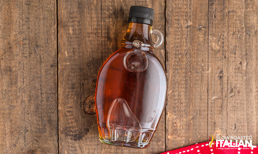 jar of maple syrup on a wooden board
