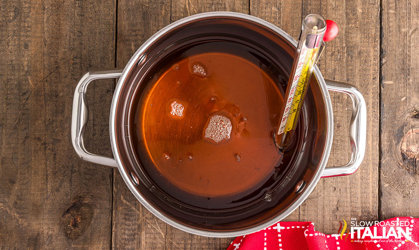 maple syrup in a medium pot with a thermometer attached