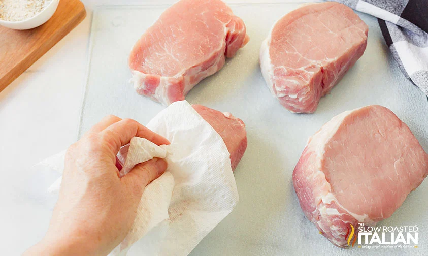 patting boneless pork chop dry with paper towel