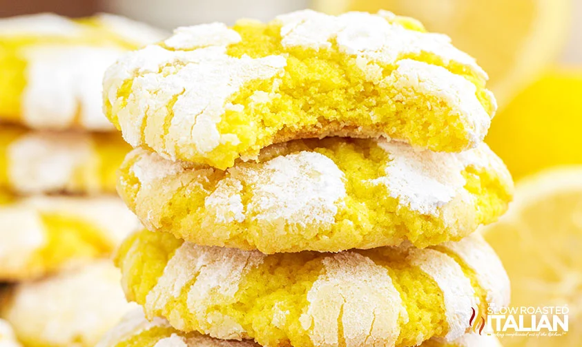 close up: stacked lemon crinkles with a bite missing from the top one