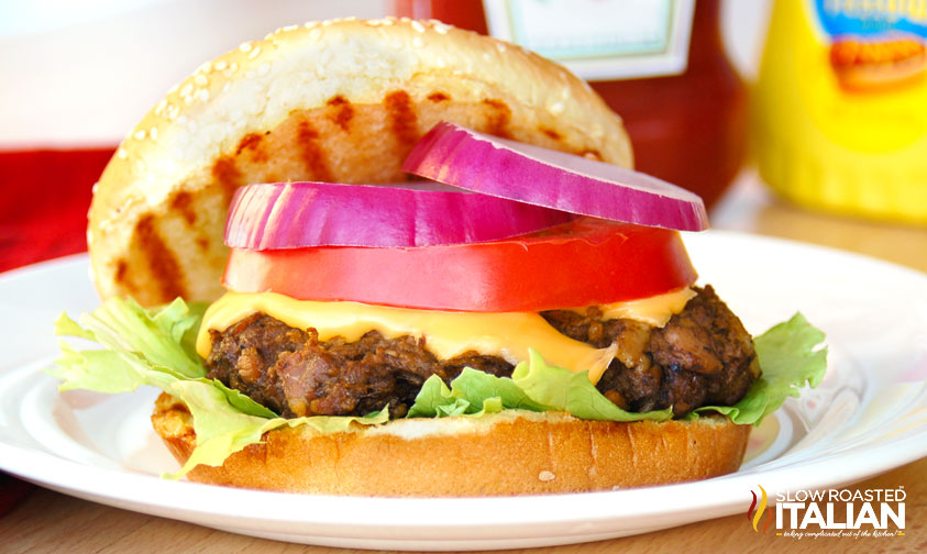 closeup of bacon in a burger with toppings