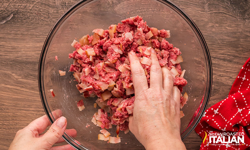 combining ground beef and bacon in a large bowl
