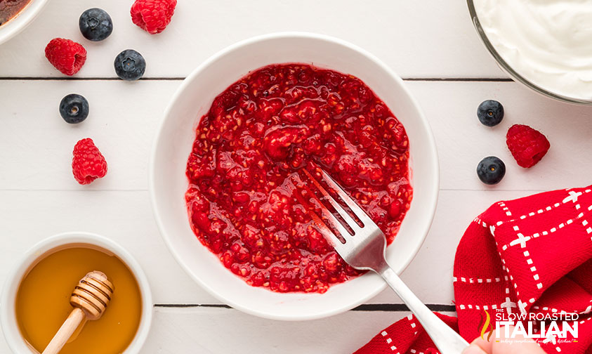mashed raspberries in a bowl