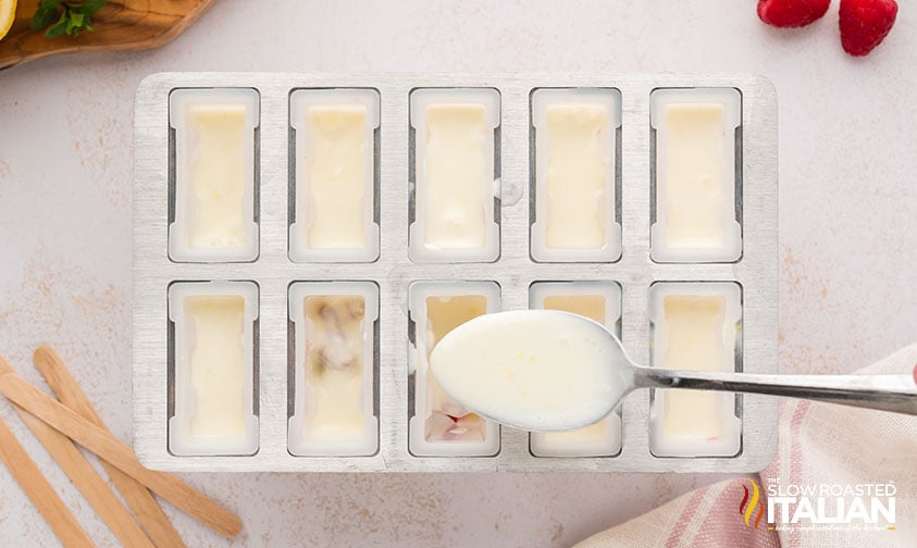 adding mixture to ice pop molds