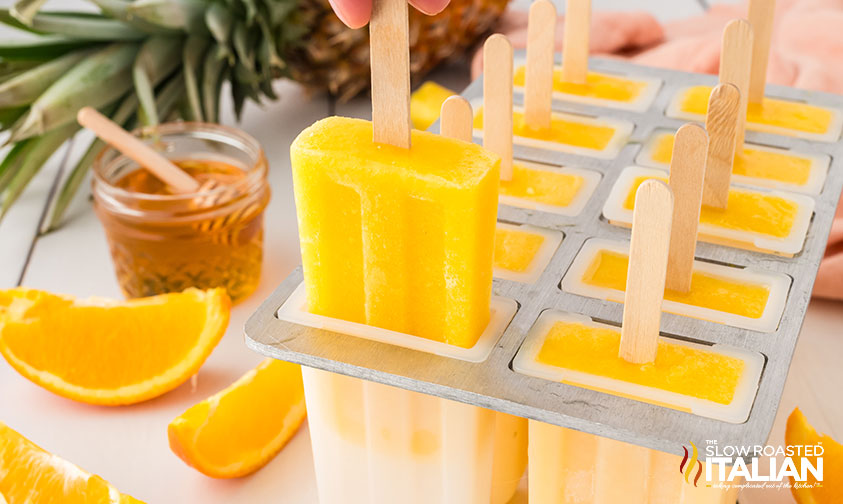 demolding a pineapple orange popsicle
