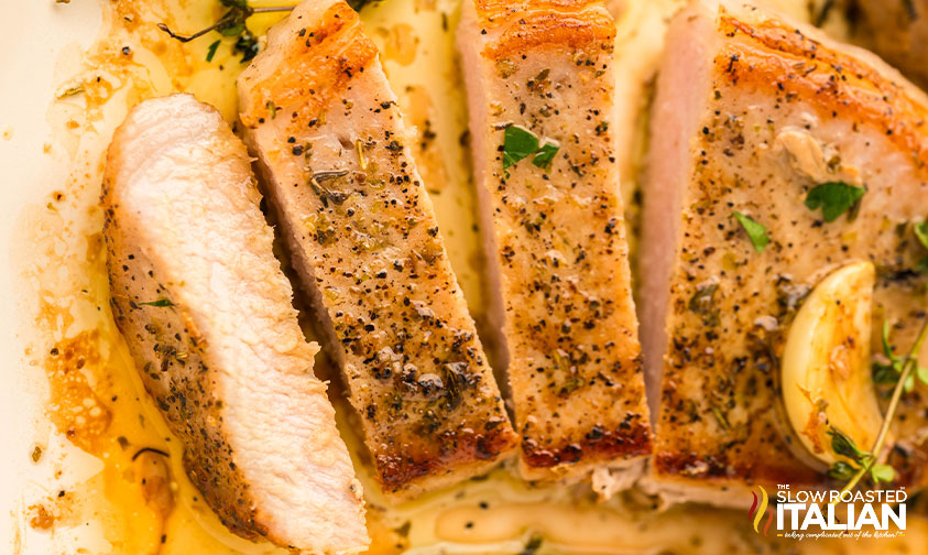 sliced pan seared pork chop on a plate