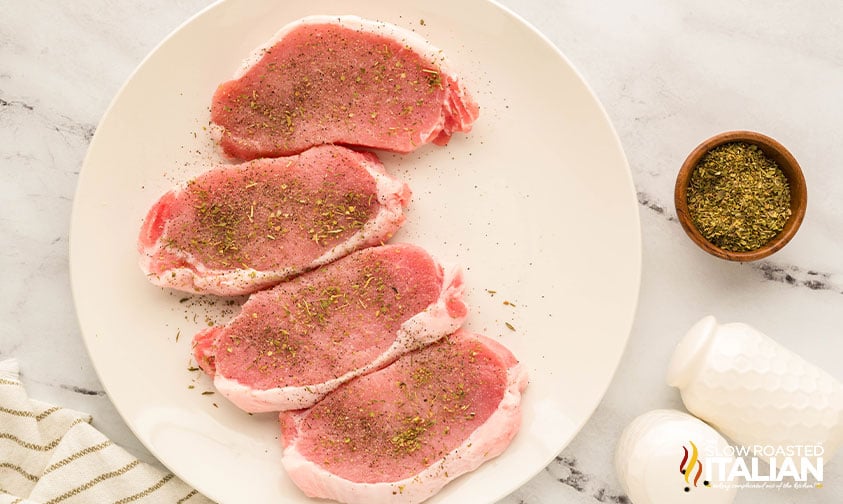 4 seasoned pok chops on a plate