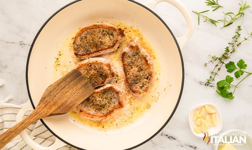 pan seared pork chops in a skillet
