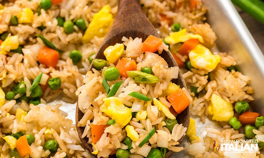 baked sheet pan fried rice on a wooden spoon