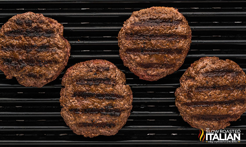 4 burger patties on a grill