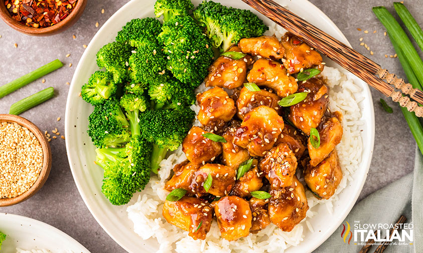 sticky honey garlic chicken bites over rice with a side of broccoli