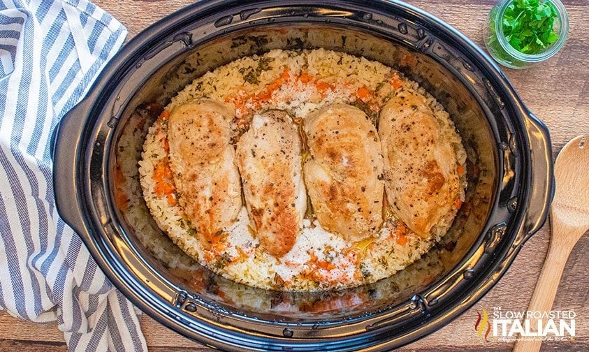 seared chicken breasts in slow cooker with ingredients for chicken and rice