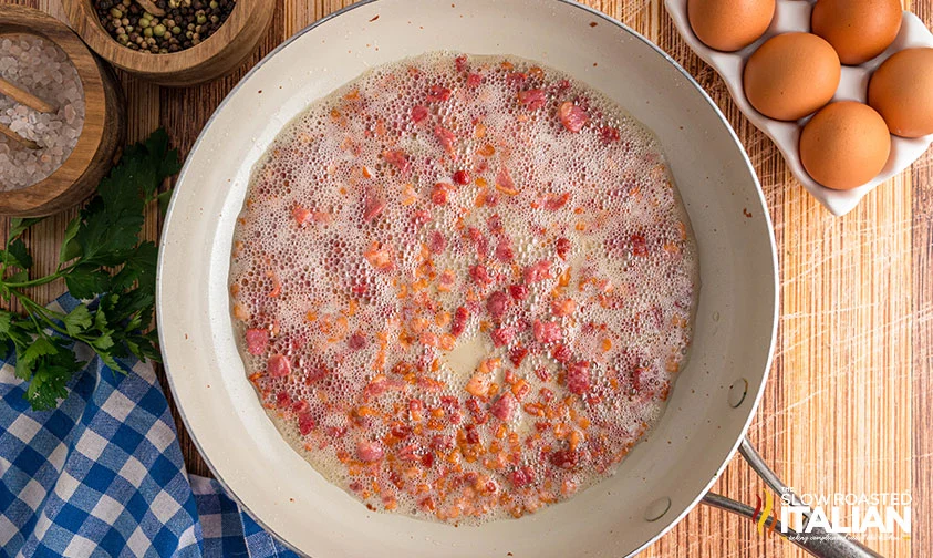 cooking chopped bacon in a skillet