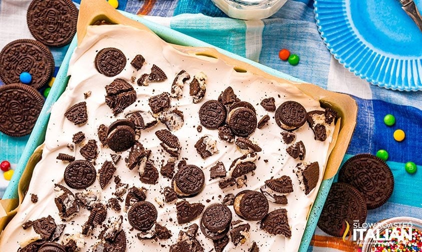 ice cream sandwich cake topped with mini Oreos and crushed cookies