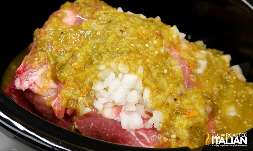 pork shoulder smothered in onions and green salsa in slow cooker