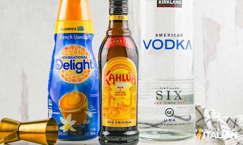 bottles of Kirkland vodka, Kahlua, and International Delight coffee creamer to make a white russian cocktail