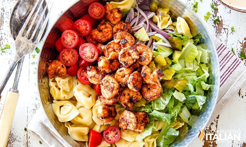 overhead: shrimp tortellini pasta salad ingredients in a large bowl
