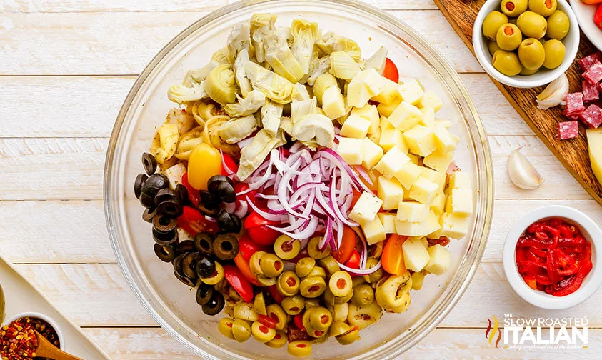 antipasto salad ingredients piled into a bowl
