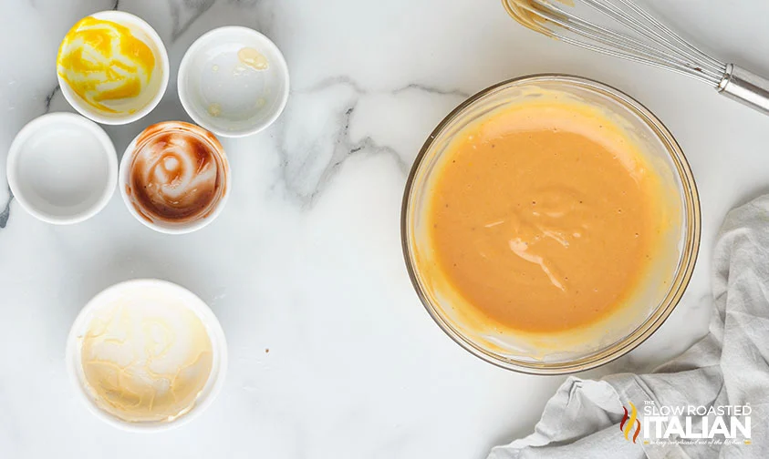 bowl of whisked chick-fil-a sauce next to empty prep bowls