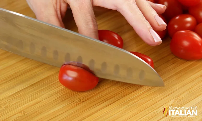 slicing grape tomatoes in half