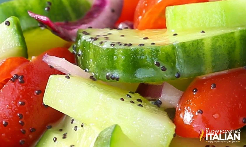 closeup: tomato and cucumber salad with lemon poppyseed dressing