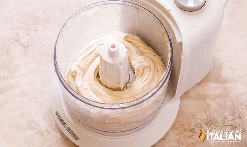 creamy mixture of blended frozen bananas in food processor