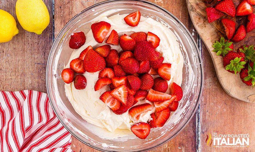 fresh strawberries in a bowl of cheesecake salad