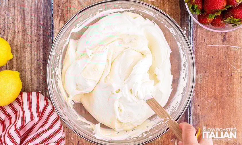 folding whipped cream into cheesecake mixture