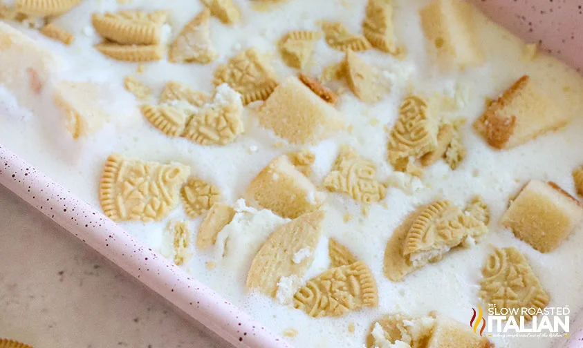 crushed golden Oreos and cubes of pound cake in no churn ice cream mixture