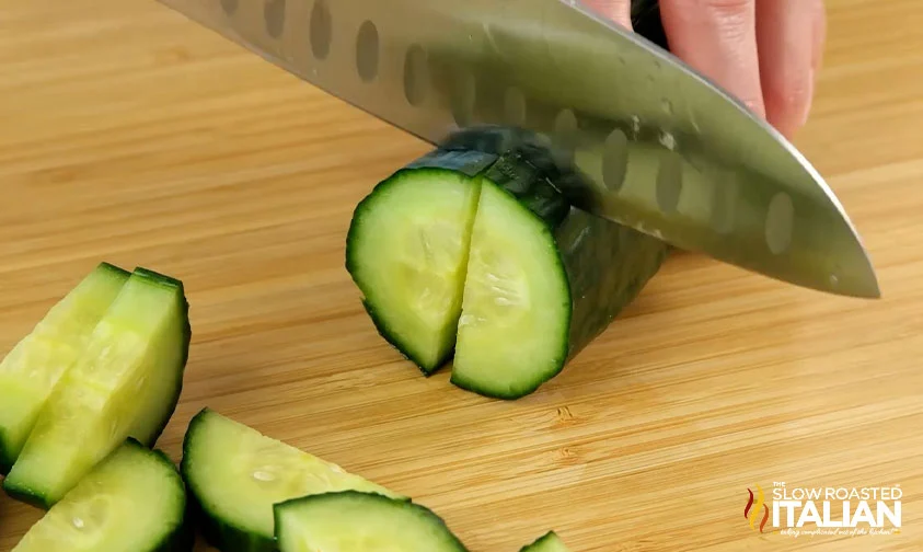 slicing an english cucumber into halved rounds