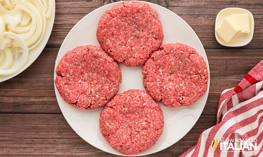 philly cheesesteak burger patties on a plate