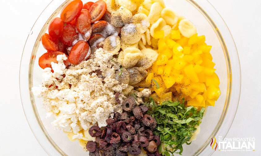 orecchiette pasta salad ingredients in a mixing bowl