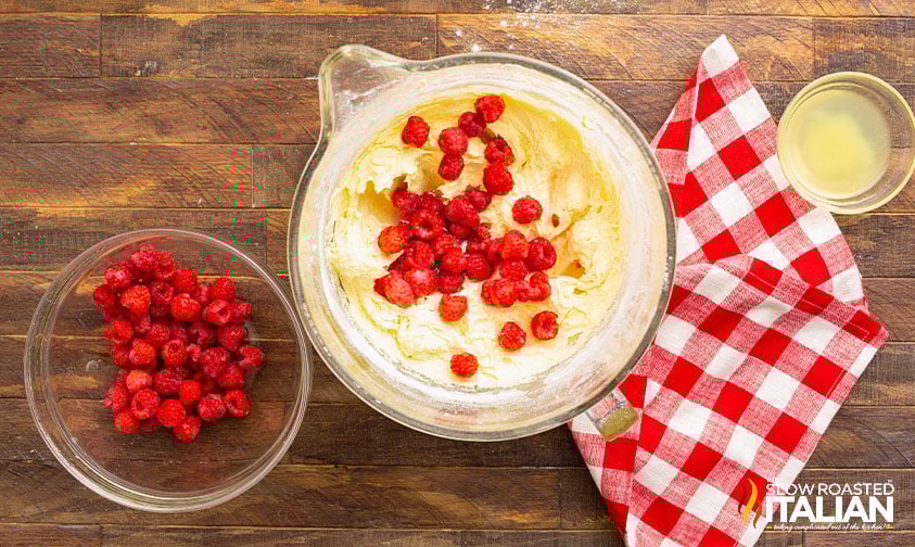 overhead: adding berries to raspberry lemon bundt cake batter