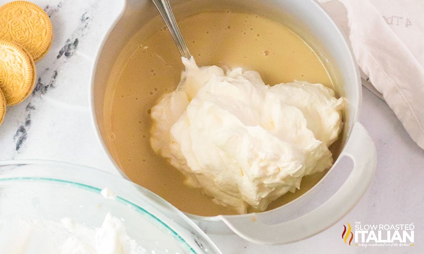 mixing whipped heavy cream with condensed milk for red white and blue ice cream