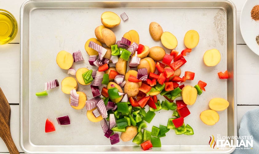 potatoes, peppers, and onions on a baking sheet