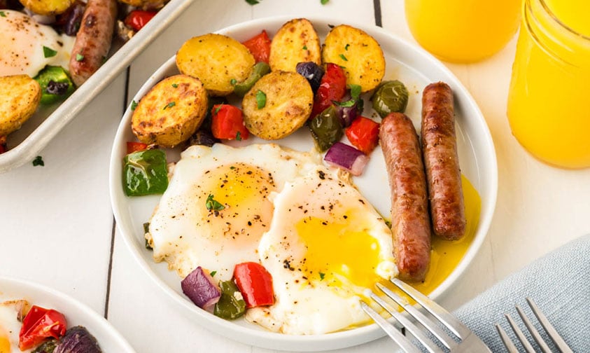 sheet pan fried eggs, sausage, and veggies on a plate